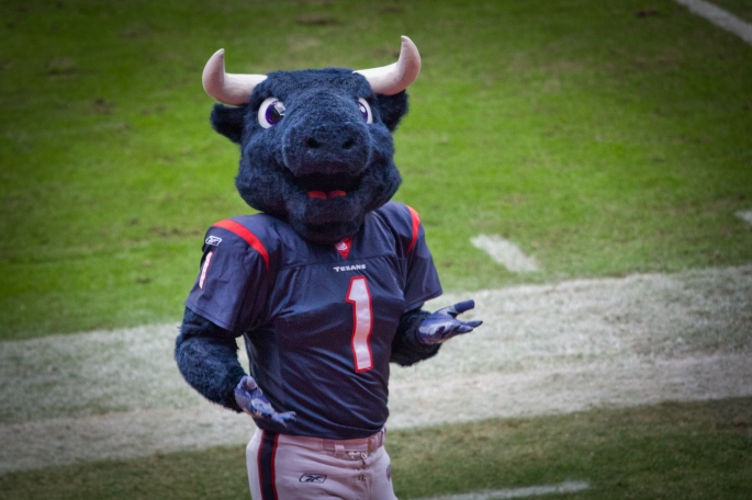 A blue bull mascot entertains football fans.